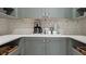 Convenient coffee bar area with custom cabinetry, quartz countertops, and stylish backsplash at 1613 Bellagio Loop, Tavares, FL 32778