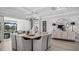 Dining room with seating for eight, patterned wallpaper, and modern light fixture at 1613 Bellagio Loop, Tavares, FL 32778