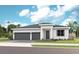 Charming single-Gathering home with a two-car garage, beautifully landscaped front yard, and modern architectural details at 1613 Bellagio Loop, Tavares, FL 32778