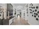 Bright foyer with white trim, light wood floors, unique art features, and a view to the backyard at 1613 Bellagio Loop, Tavares, FL 32778