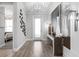 Inviting foyer with elegant lighting, stylish decor, and hardwood flooring at 1613 Bellagio Loop, Tavares, FL 32778