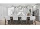 Modern kitchen featuring a large island with seating, stainless steel appliances, and stylish pendant lighting at 1613 Bellagio Loop, Tavares, FL 32778