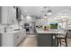 Open-concept kitchen with a large island, stainless steel appliances, and elegant cabinetry at 1613 Bellagio Loop, Tavares, FL 32778