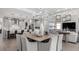 Open-concept kitchen, dining, and living areas with a modern design and light color scheme at 1613 Bellagio Loop, Tavares, FL 32778