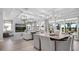 Open-concept living and dining areas with modern furnishings and patio access at 1613 Bellagio Loop, Tavares, FL 32778