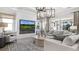 Comfortable living room with modern fireplace, large television, neutral colors, and view to patio at 1613 Bellagio Loop, Tavares, FL 32778