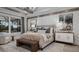 Luxurious main bedroom with a decorative accent wall, elegant furnishings, and ample natural light at 1613 Bellagio Loop, Tavares, FL 32778