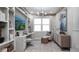 Bright home office with custom built-ins, stylish decor, and a comfortable seating area at 1613 Bellagio Loop, Tavares, FL 32778