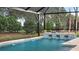 Beautiful pool area with integrated water features surrounded by well-maintained landscaping, perfect for relaxation at 1613 Bellagio Loop, Tavares, FL 32778