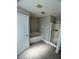 Bathroom featuring a tub and separate shower with neutral walls and tile flooring at 1715 Redfin Way, Kissimmee, FL 34759