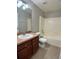 Bathroom featuring a sink, toilet and shower-tub combo with tile flooring at 1715 Redfin Way, Kissimmee, FL 34759