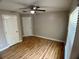 Bedroom featuring a ceiling fan, window and wood flooring at 1715 Redfin Way, Kissimmee, FL 34759