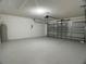 Garage featuring concrete flooring and a garage door at 1715 Redfin Way, Kissimmee, FL 34759