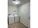 Laundry room featuring a washer and dryer with tile flooring at 1715 Redfin Way, Kissimmee, FL 34759