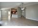 Open-concept living room with tile floors, neutral paint, and seamless flow to kitchen at 1715 Redfin Way, Kissimmee, FL 34759