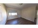 Bedroom space with laminate wood flooring, window with shade, light paint, and white door at 2031 Warrens Ave, Maitland, FL 32751