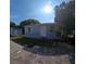 Exterior view of home featuring blue paint, white door, and detached shed on a sunny day at 2031 Warrens Ave, Maitland, FL 32751