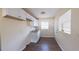 Functional kitchen area featuring bright lighting, white cabinets, a window, and wood-look floors at 2031 Warrens Ave, Maitland, FL 32751