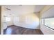 Well-lit living room featuring neutral paint, wood floors, and a large window with blinds at 2031 Warrens Ave, Maitland, FL 32751