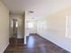 Open living space featuring wood floors, neutral wall paint, and access to hallway and kitchen at 2031 Warrens Ave, Maitland, FL 32751