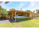 Cozy exterior view features a carport with a parked car and well-maintained landscaping at 2272 Raeford Rd # A-3, Orlando, FL 32806