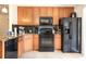 Efficient kitchen with sleek black appliances and ample cabinet storage at 2272 Raeford Rd # A-3, Orlando, FL 32806