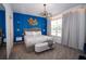 Stunning bedroom features a plush bed, elegant lighting, and a striking blue accent wall at 2379 Distant Sun Trl, Kissimmee, FL 34747