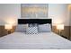 Comfortable bedroom featuring neutral tones, decorative pillows, and stylish lamps at 2379 Distant Sun Trl, Kissimmee, FL 34747