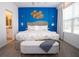Chic bedroom with a plush bed, statement lighting, and access to the en-suite bathroom at 2379 Distant Sun Trl, Kissimmee, FL 34747