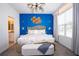 Stylish bedroom with a comfortable bed, modern lighting, and en-suite bathroom access at 2379 Distant Sun Trl, Kissimmee, FL 34747