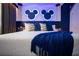 This bedroom features a comfortable bed with plush pillows, highlighted by a modern design, and stylish themed lighting at 2379 Distant Sun Trl, Kissimmee, FL 34747