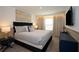 Relaxing bedroom features neutral tones, a comfortable bed, and a mounted television at 2379 Distant Sun Trl, Kissimmee, FL 34747