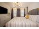 The bedroom offers a serene retreat, complete with a modern light fixture, padded headboard and neutral decor at 2379 Distant Sun Trl, Kissimmee, FL 34747