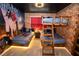 This Harry Potter-themed bedroom has bunkbeds, brick walls, and Hogwarts decor for an immersive experience at 2379 Distant Sun Trl, Kissimmee, FL 34747