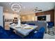 Open concept living and dining area with modern lighting and stylish blue chairs at the dining table at 2379 Distant Sun Trl, Kissimmee, FL 34747