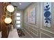 Inviting hallway with modern lighting, decorative artwork, and a chic entryway table at 2379 Distant Sun Trl, Kissimmee, FL 34747