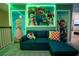 Whimsical game room featuring vibrant Mario-themed decor, a plush sofa, and neon accents for an immersive experience at 2379 Distant Sun Trl, Kissimmee, FL 34747