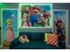 Whimsical game room featuring vibrant Mario-themed decor, a plush sofa, and neon accents for an immersive experience at 2379 Distant Sun Trl, Kissimmee, FL 34747