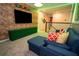 This Super Mario game room has brick walls, turf flooring, and a plush couch for an immersive gaming experience at 2379 Distant Sun Trl, Kissimmee, FL 34747