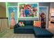Whimsical game room featuring vibrant Mario-themed decor, a plush sofa, and neon accents for an immersive experience at 2379 Distant Sun Trl, Kissimmee, FL 34747