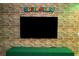 This Super Mario game room has brick walls, turf flooring, and a TV for an immersive gaming experience at 2379 Distant Sun Trl, Kissimmee, FL 34747