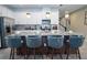Modern kitchen with white cabinets, granite countertops, stainless steel appliances and island with seating at 2379 Distant Sun Trl, Kissimmee, FL 34747