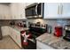 Gourmet kitchen features stainless steel appliances, granite countertops, and white cabinets at 2379 Distant Sun Trl, Kissimmee, FL 34747