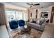 Modern living room with stylish seating and access to a screened-in pool area at 2379 Distant Sun Trl, Kissimmee, FL 34747