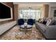 Modern living room featuring stylish furniture, a plush rug, and access to an outdoor pool area at 2379 Distant Sun Trl, Kissimmee, FL 34747