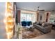 Comfortable living room with a view of the screened-in patio and pool area at 2379 Distant Sun Trl, Kissimmee, FL 34747