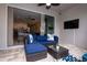 Covered patio area with blue wicker furniture and a view into the house at 2379 Distant Sun Trl, Kissimmee, FL 34747