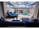 Inviting screened-in pool area with cozy lounge seating and a refreshing pool at 2379 Distant Sun Trl, Kissimmee, FL 34747