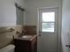 Bathroom features a modern vanity and door to outside pool at 2632 Derbyshire Rd, Maitland, FL 32751