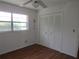 Bright bedroom with a window, ceiling fan, wood floors and a spacious closet with bi-fold doors at 2632 Derbyshire Rd, Maitland, FL 32751